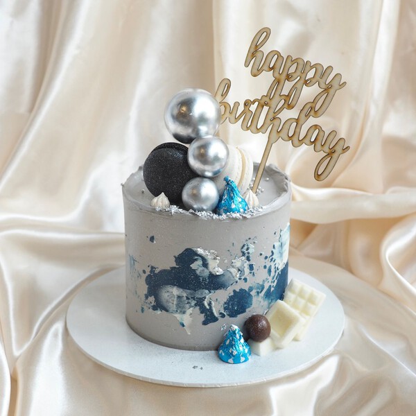 Small cake with a birthday candle - Stock Photo - Dissolve